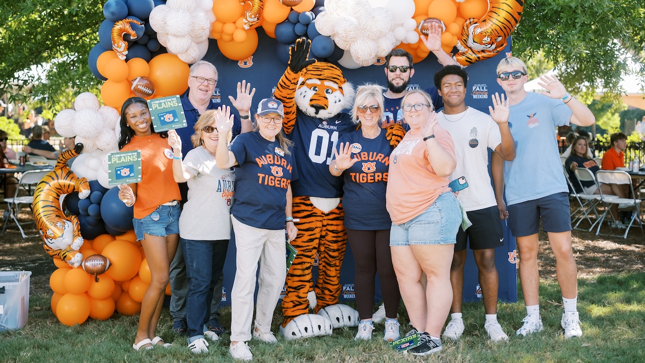 people taking a group photo at the 2026 fall family tailgate