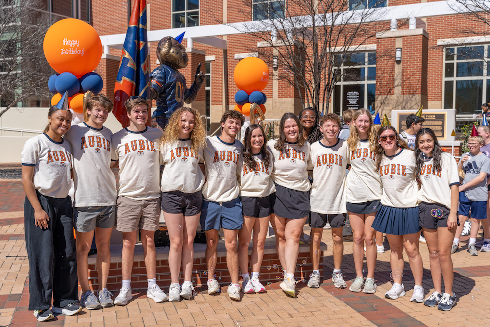 sga members posing in front of Aubie's statue