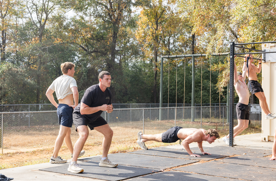 Men working out outdoors.