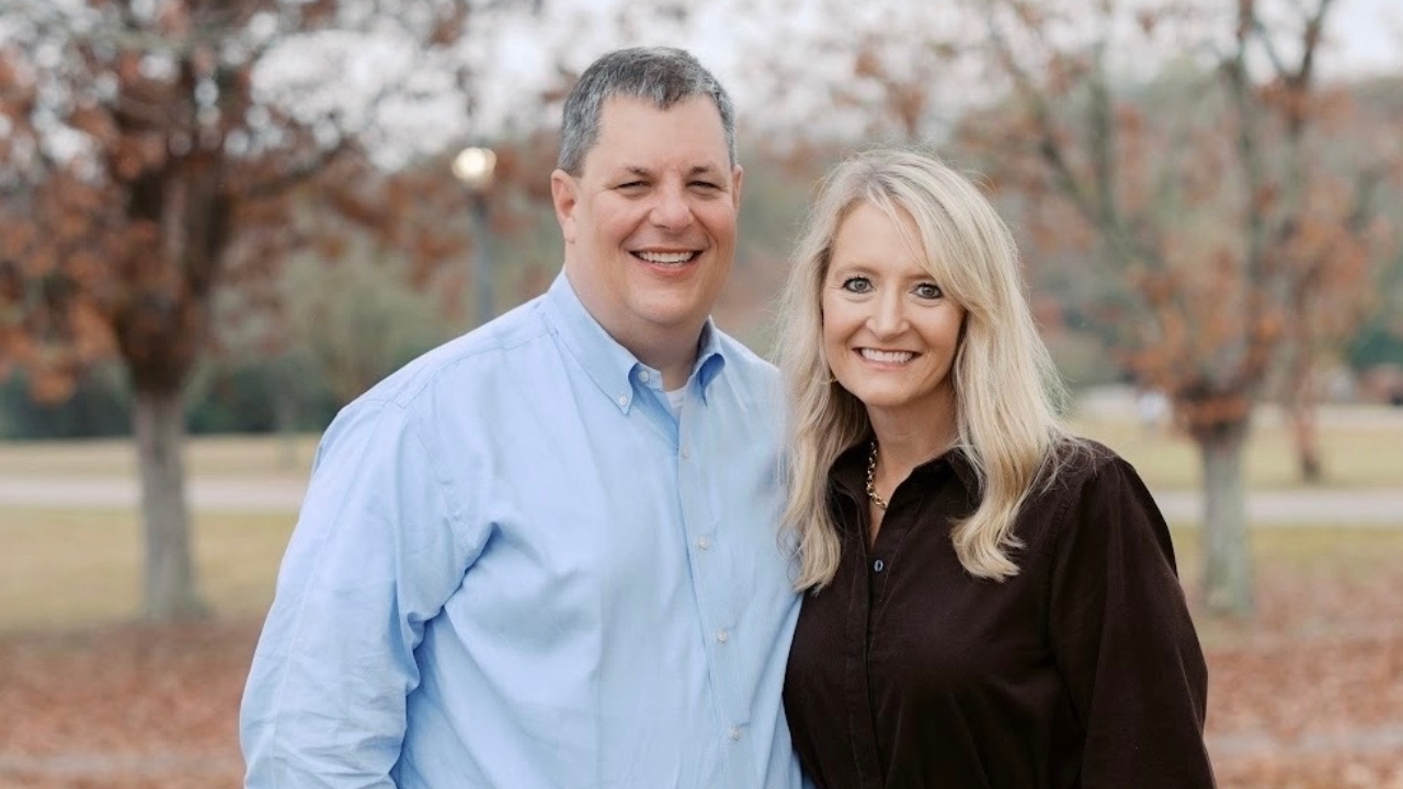 Two people smiling at the camera.