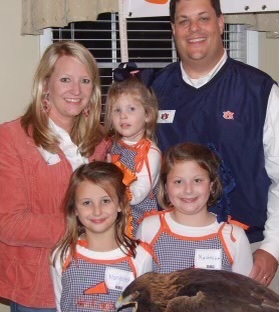 Family smiling at the camera.