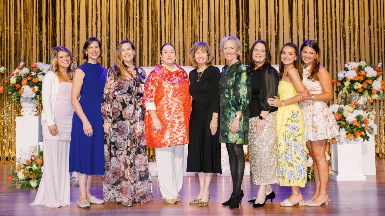 Women standing on stage smiling