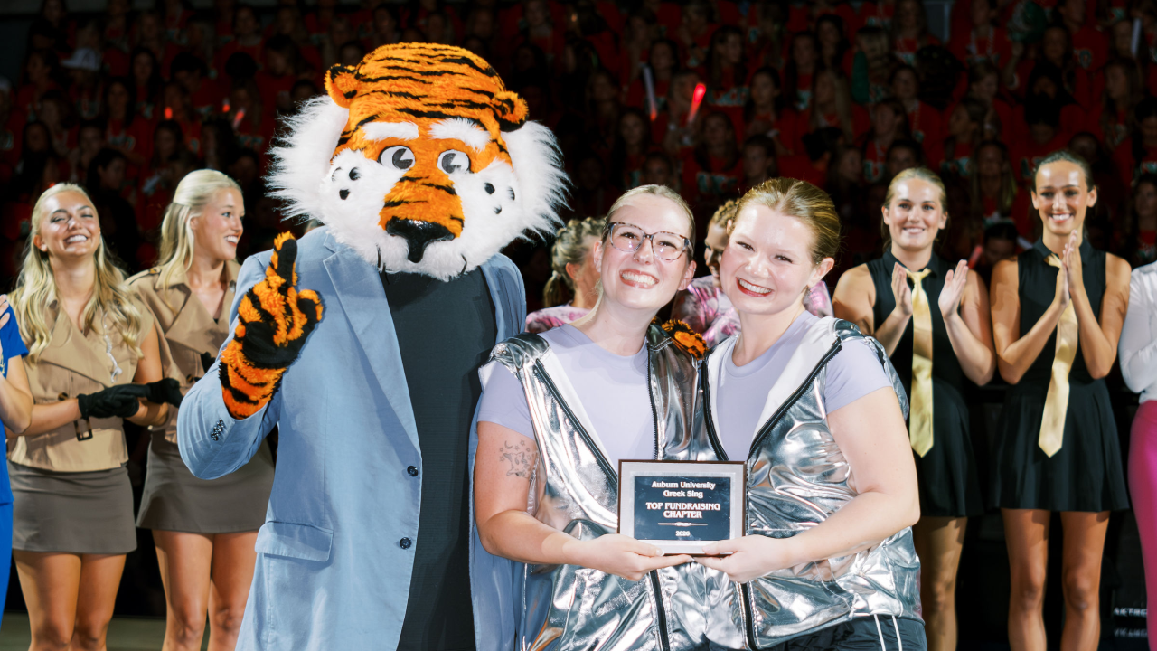 Women of Sigma Sigma Sigma posing with Aubie and holding an award plaque.