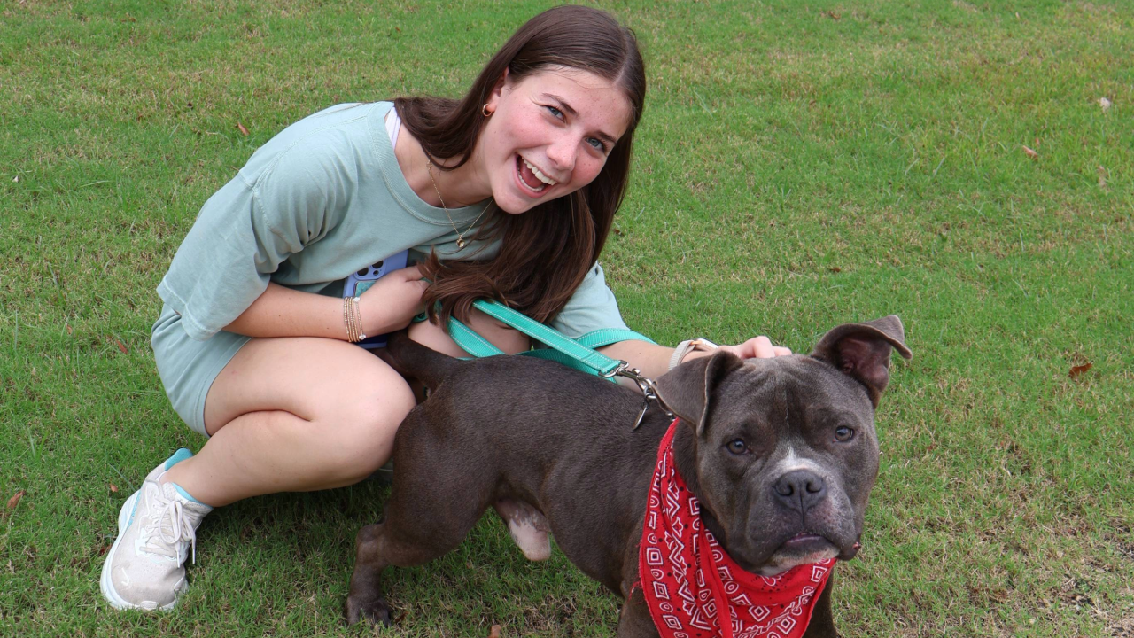 girl smiling with dog