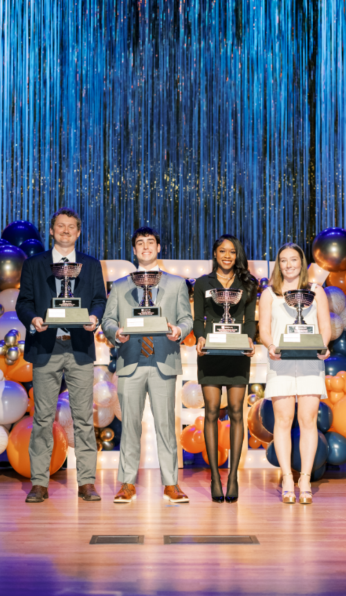Chapter of the year recipients smiling with large trophies.