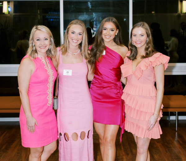 Four women smiling at the camera.