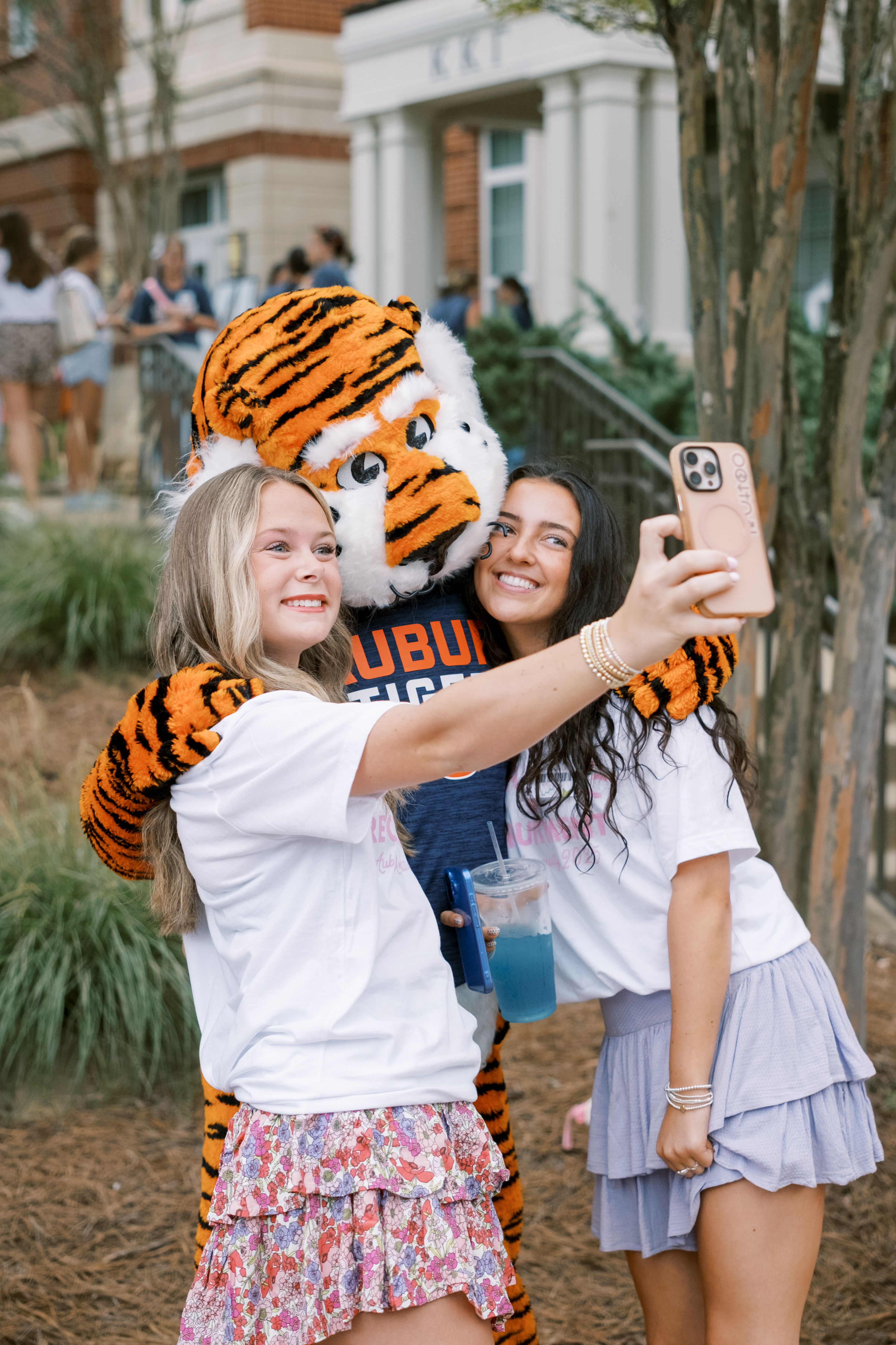 Two girls posing for a selfie with Aubie