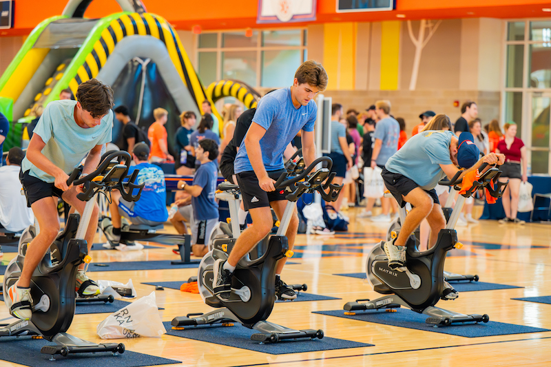 students at the rec center riding exercise bikes
