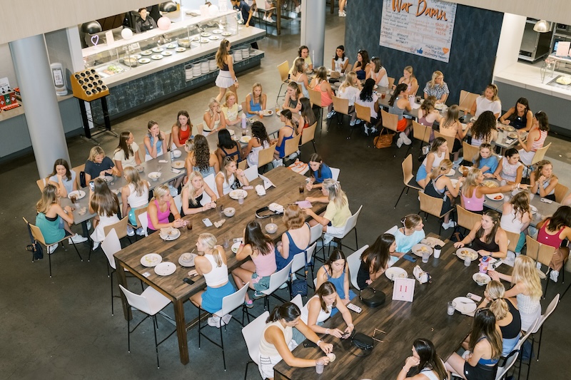 students eating at tables in the edge