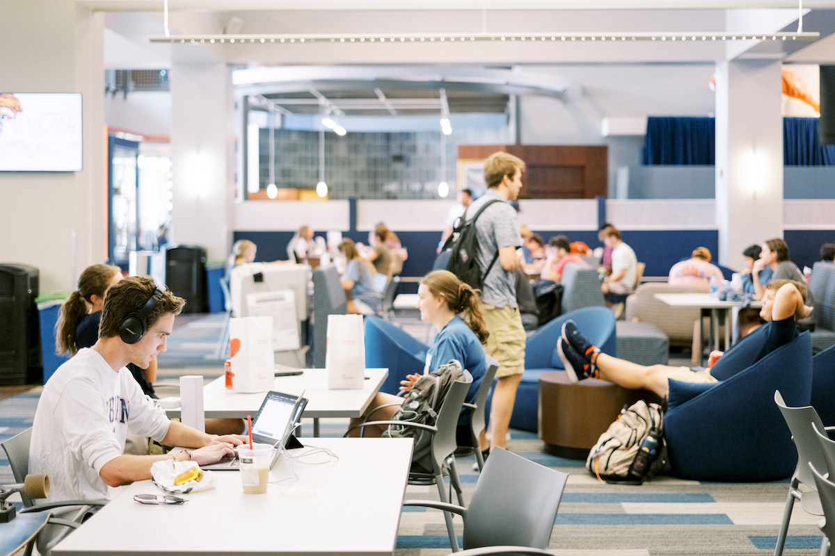 students gathering at tables in the student center