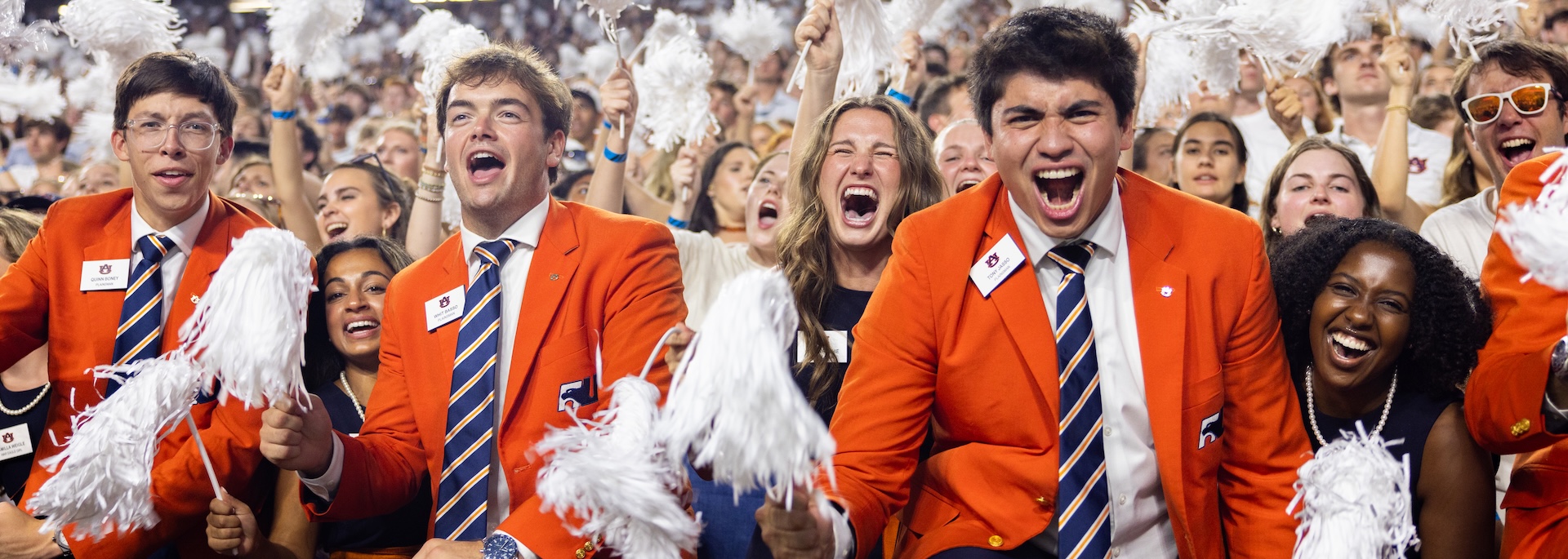 students in Jordan-Hare Stadium yelling during a game