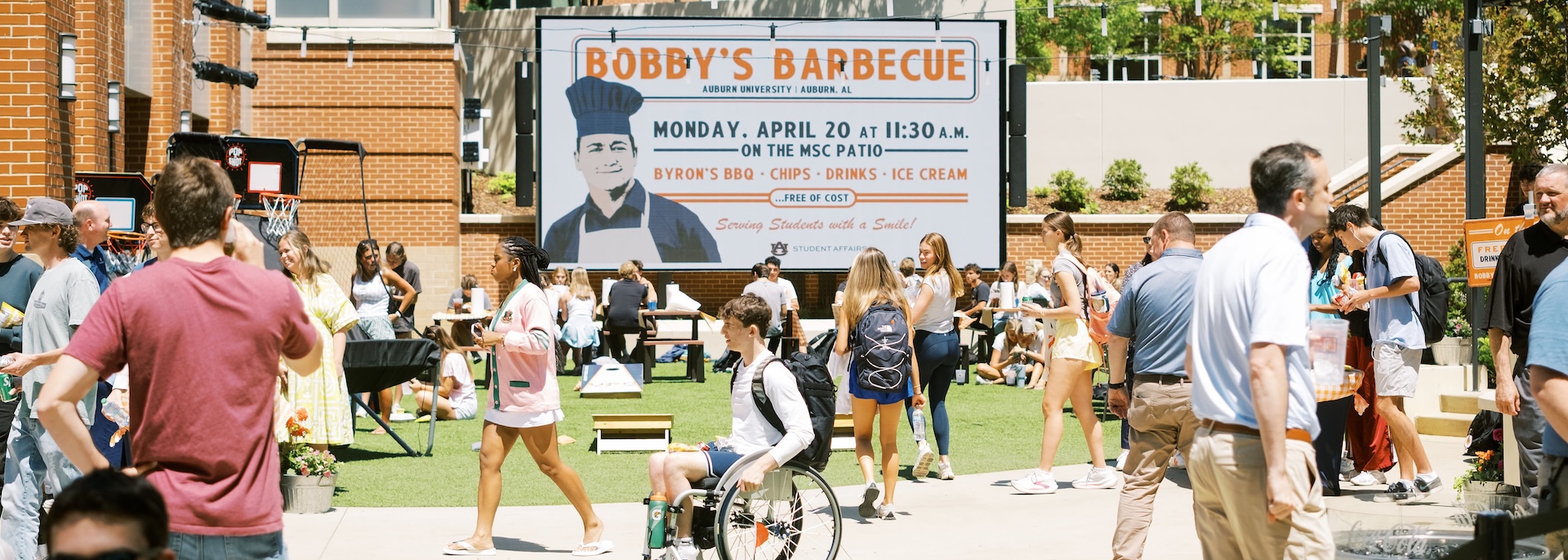 students gather at the melton student center patio for bobby's bbq event