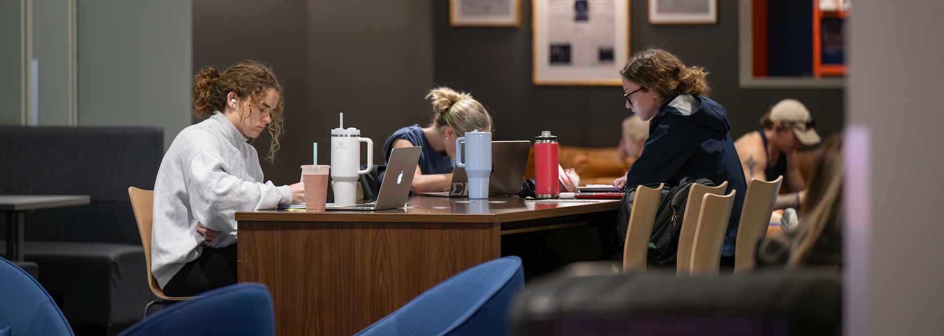 students studying at a table in the student center
