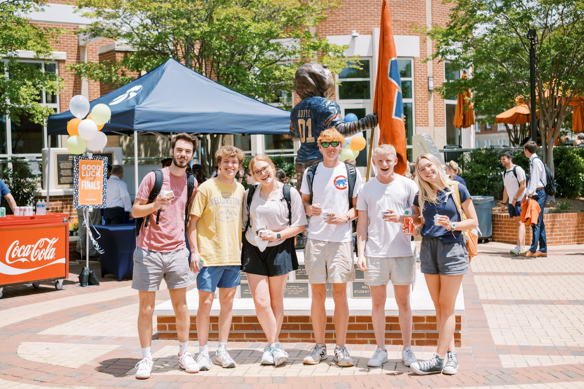 students posing for a photo by the Aubie statue before spring finals