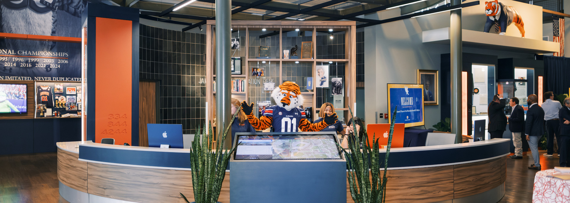 Aubie posing behind the Foy Information Desk
