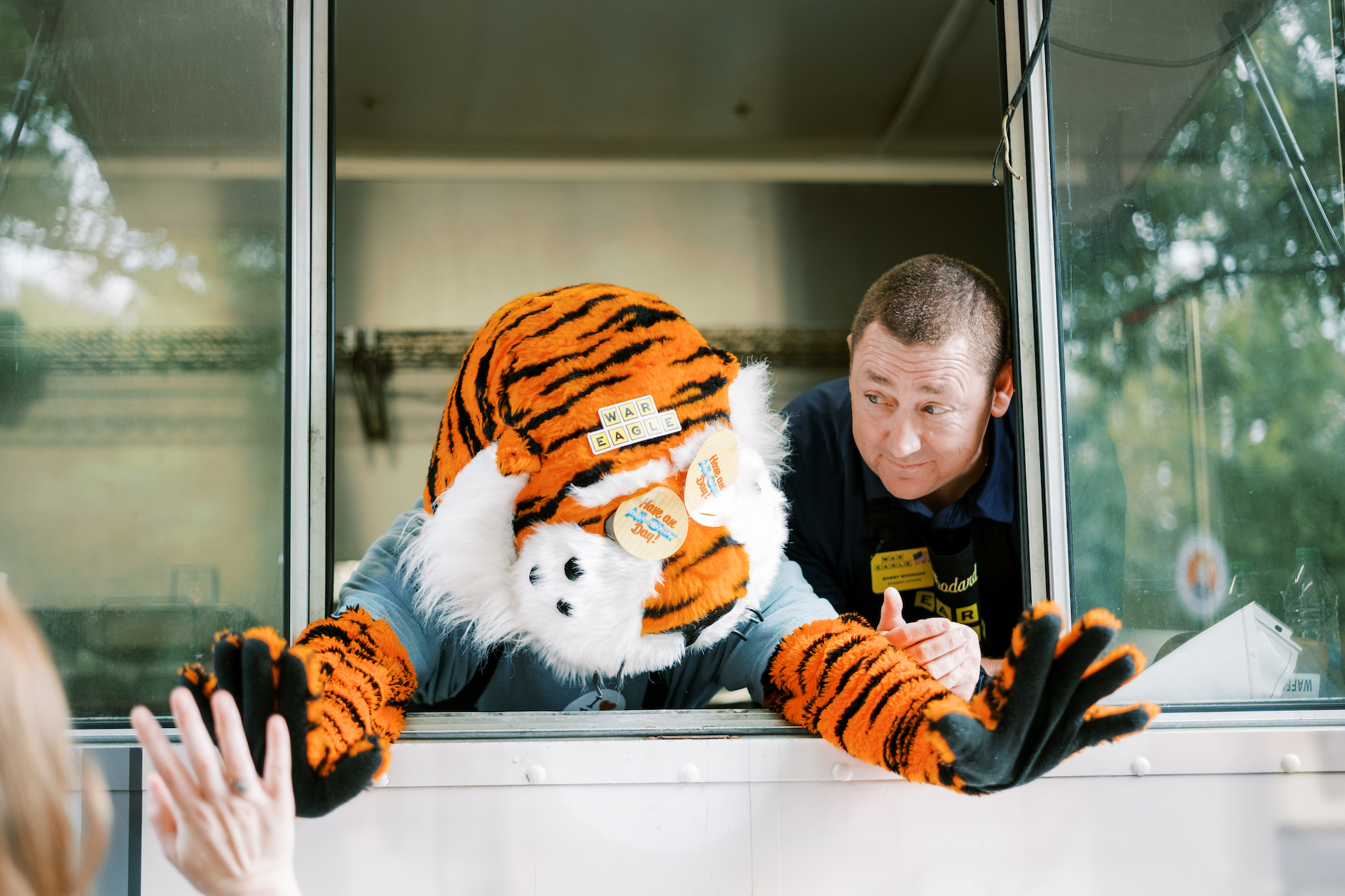 Aubie and Dr. Woodard inside the Waffle House truck greeting students