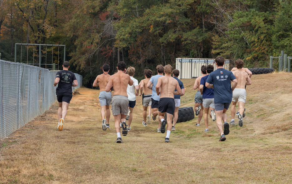 Group of men running away from the camera.