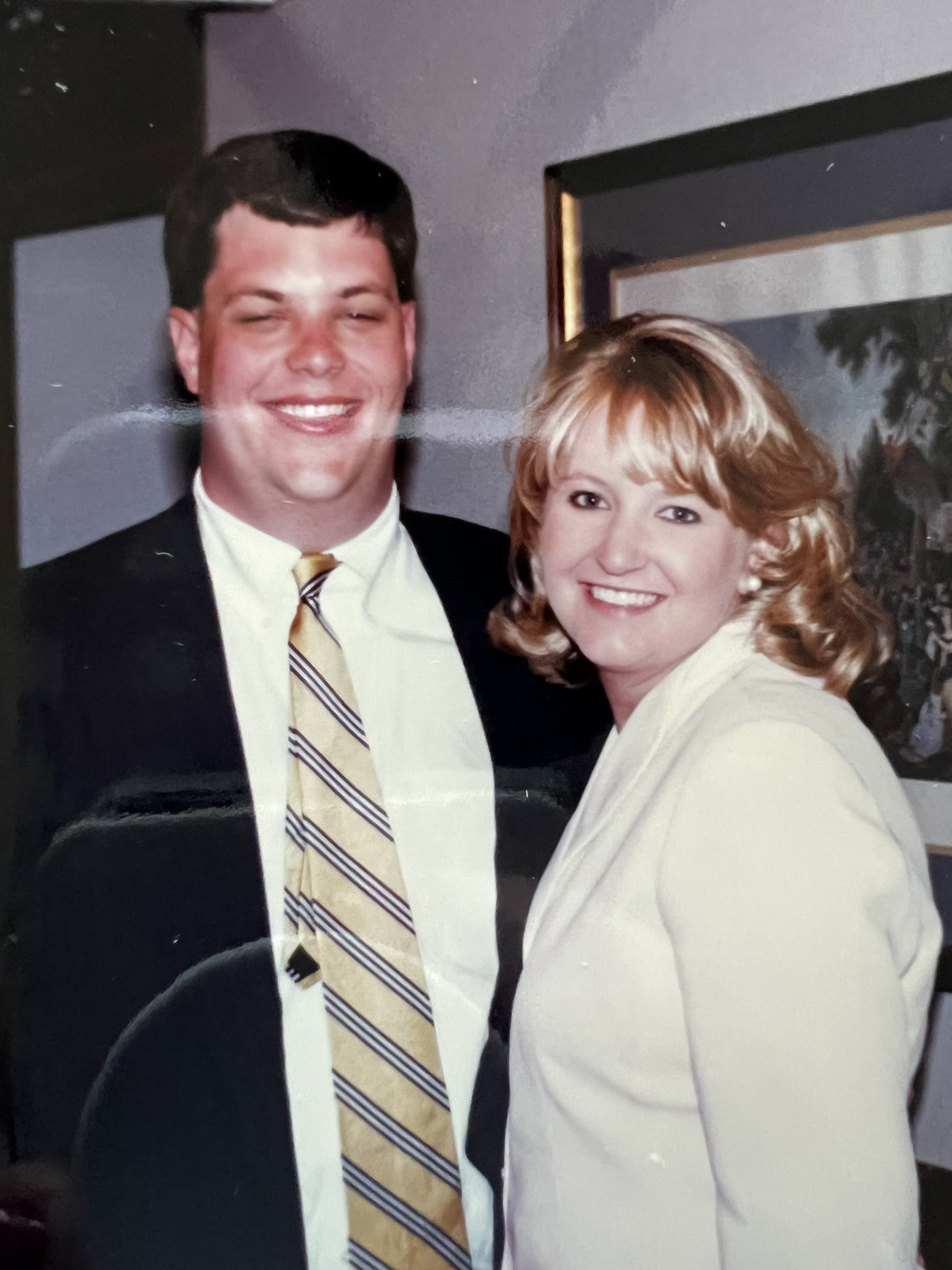 Two people smiling at the camera.