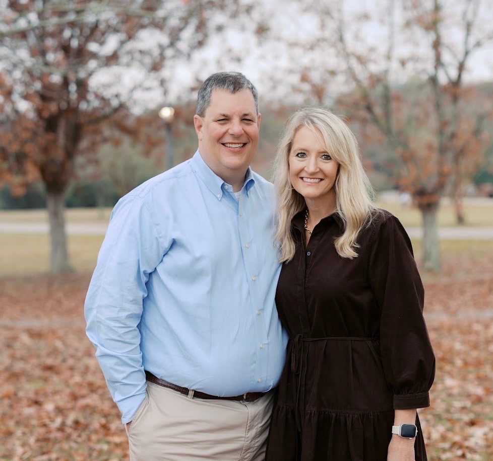 Two people smiling at the camera.