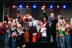 President Roberts and Aubie on stage with the AU Choir at the Holiday Lighting Ceremony