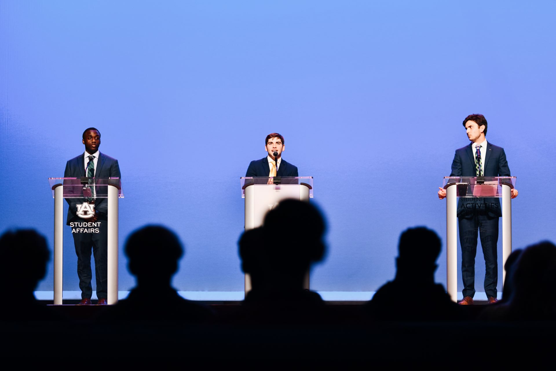 SGA candidates on stage during a debate 
