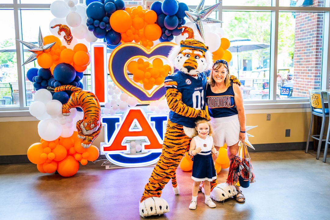 mother and daughter posing with Aubie in front of an I love AU sign