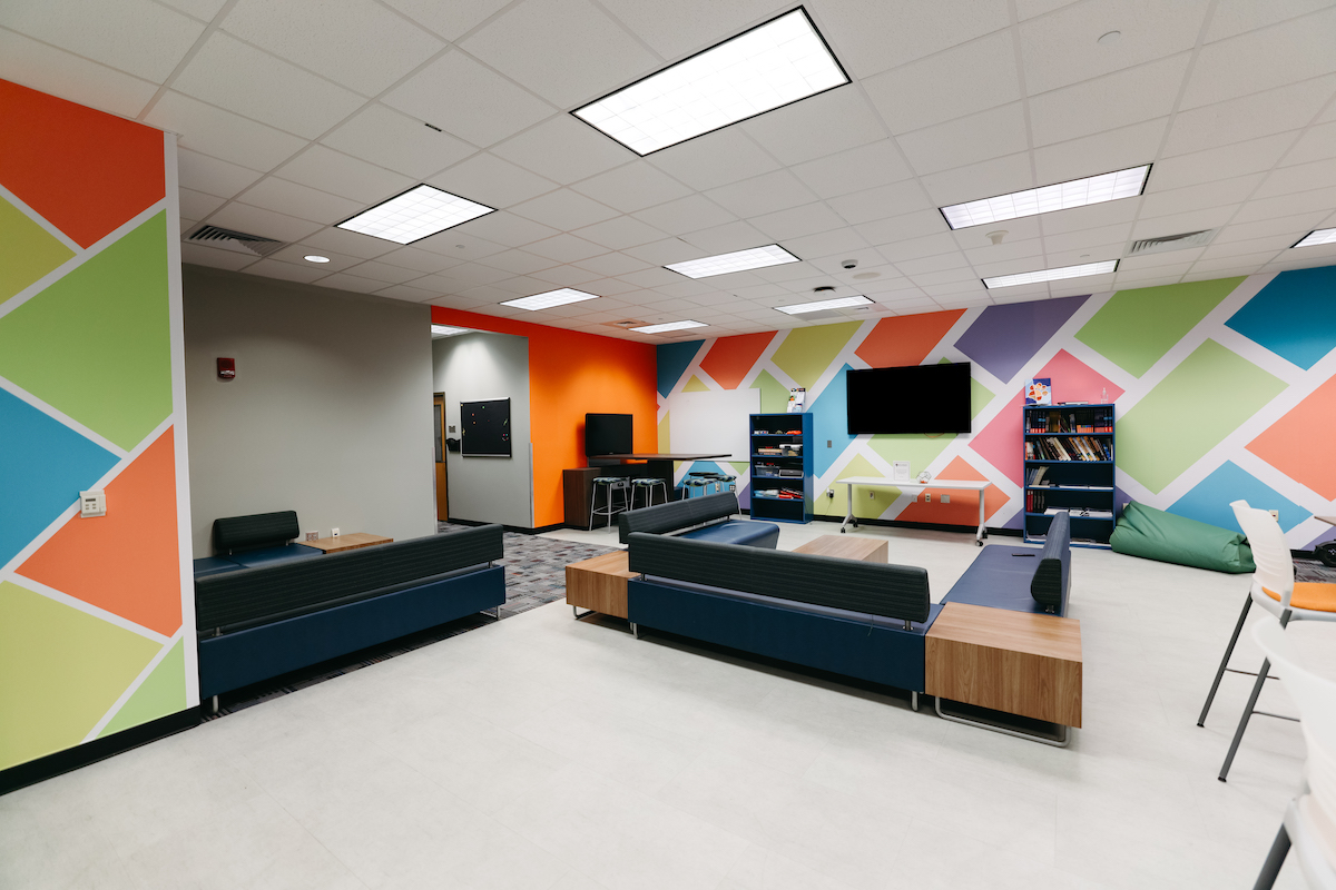 The Student Media Suite in MSC 1105 showing student workspaces, tvs on the wall, a shelf of awards and office spaces.