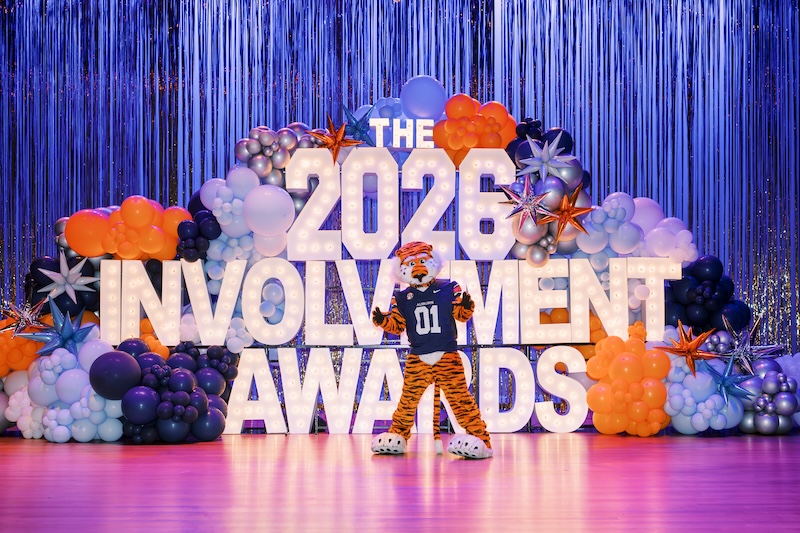 students taking a group selfie on stage in front of the Involvement Awards sign