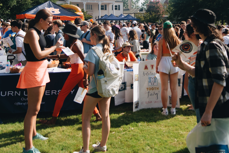 students gathering on a campus green space for the involvement fair