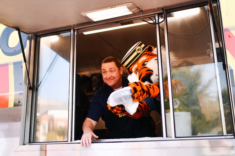 Dr. Woodard and Aubie looking out of a waffle house truck