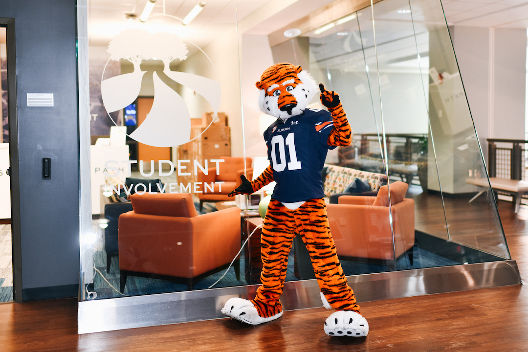 Aubie posing in front of the Student Involvement Suite, MSC 3130